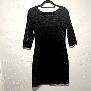 Express black 3/4 length sleeve cocktail dress with see through detail.